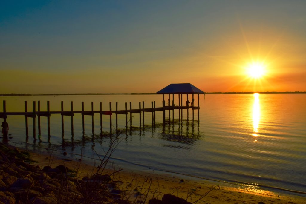 pier at beach at sunset