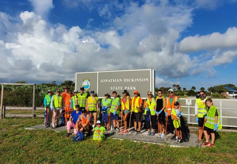 kids in safety vests in front of sign